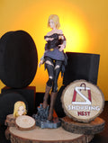 DBZ ANDROID 18 Figurine on a wooden stand with 'Shopping Nest' logo in the background