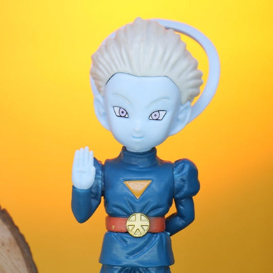 DBZ GRAND PRIEST Blue figurine on a black stand with a wooden sign reading 'Shopping Nest' in the background.