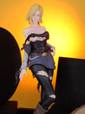 DBZ ANDROID 18 Action figure of a character in a dark outfit against a yellow background 