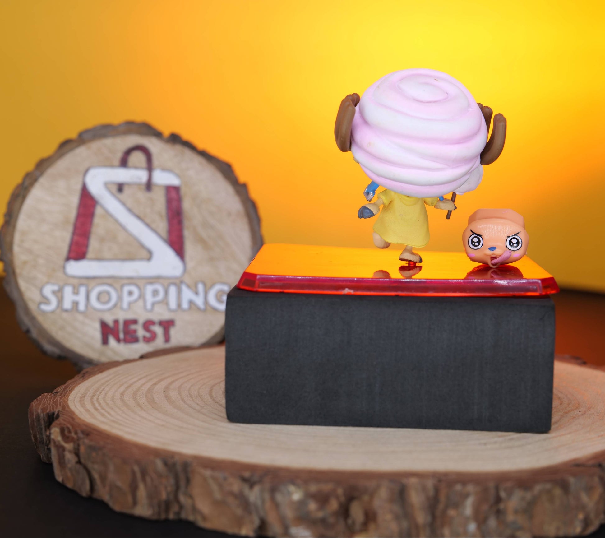 TONY CHOPPER FIGURE BACK SIDE on a reflective surface with a 'Shopping Nest' sign in the background.