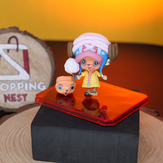 TONY CHOPPER figurinE on a reflective surface with a 'Shopping Nest' sign in the background.