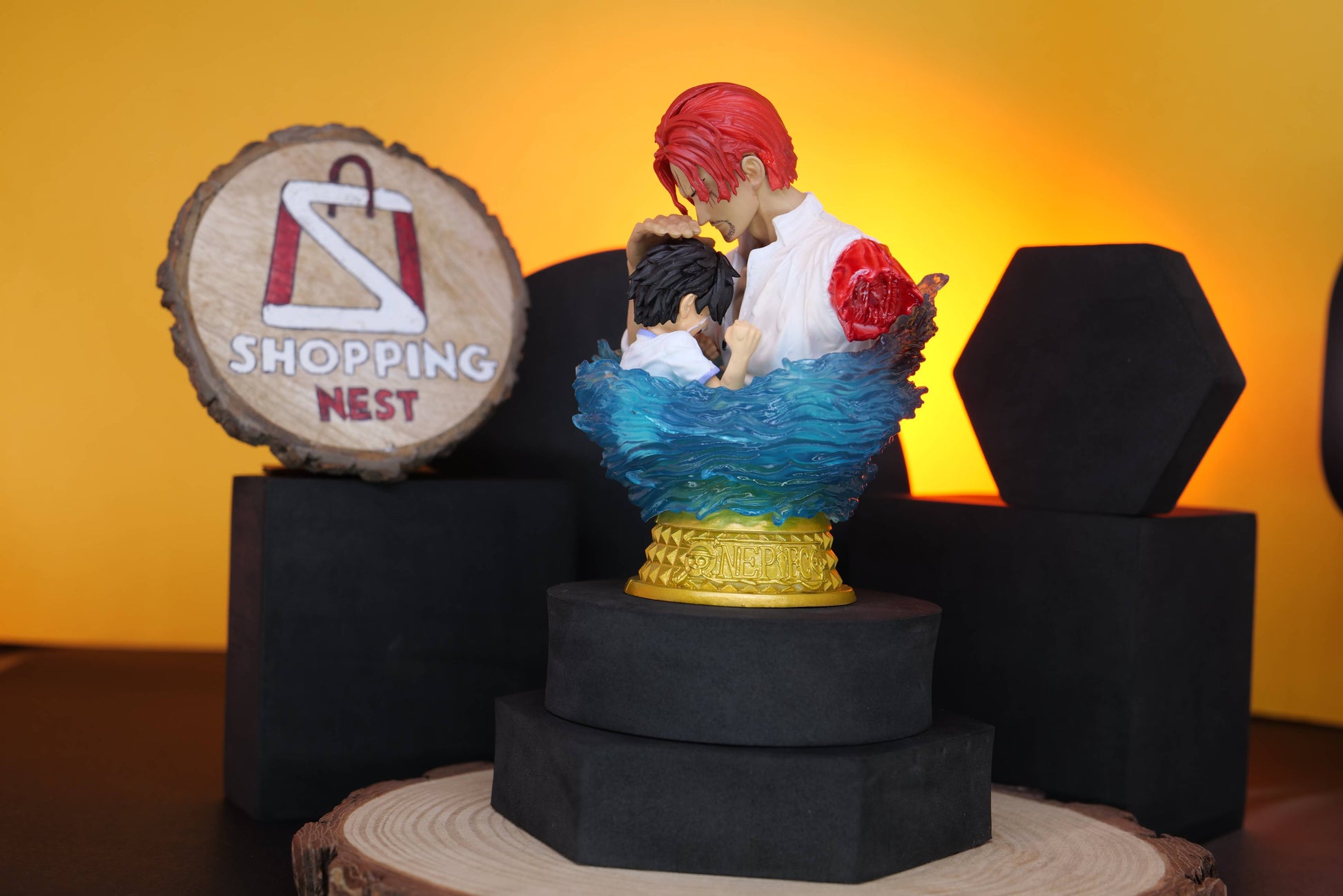 Figurine of a LUFFY AND SHANKS with red hair RIGHT SIDE on a stand with a 'Shopping Nest' sign in the background.