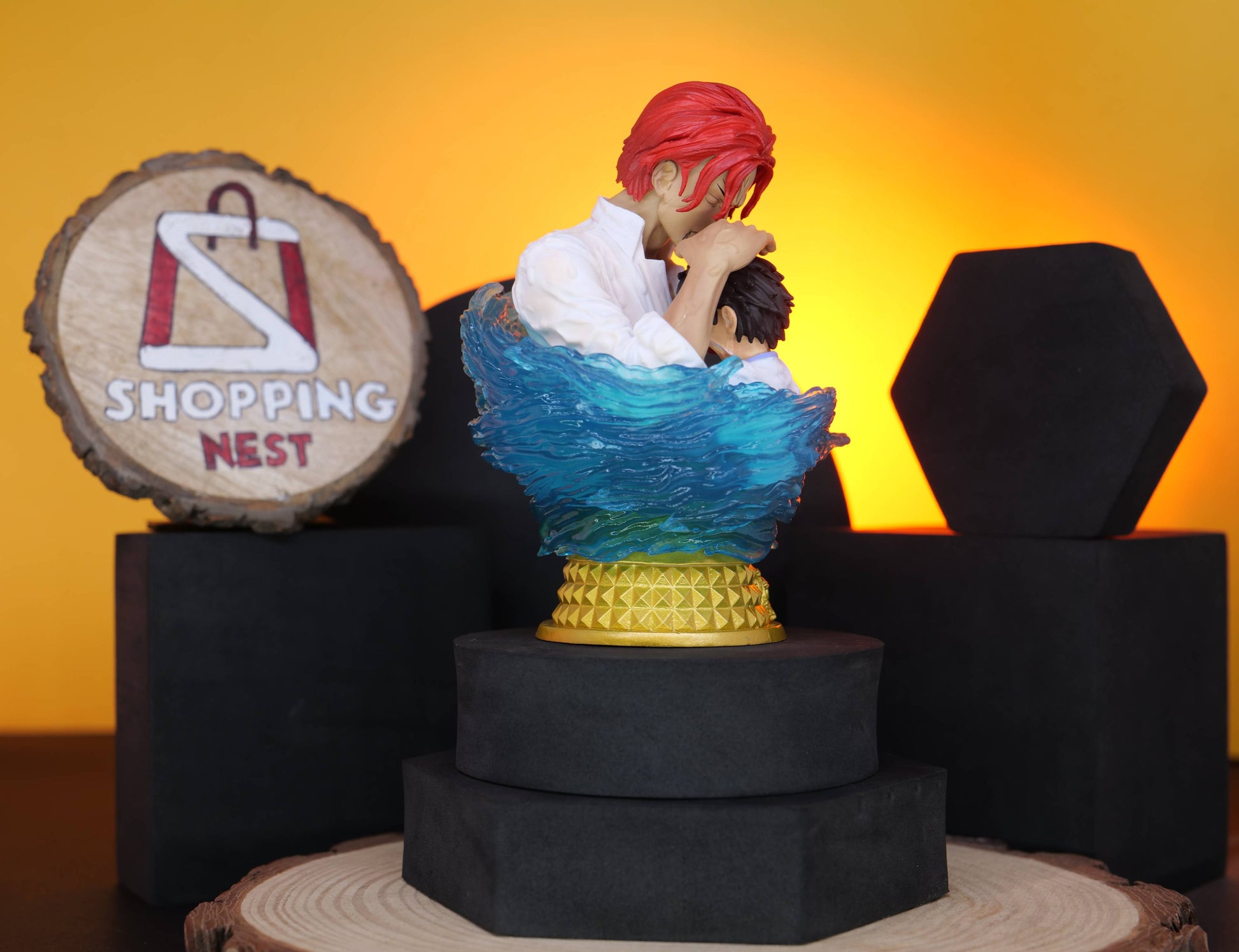 Figurine of a LUFFY AND SHANKS with red hair on a stand with a 'Shopping Nest' sign in the background.