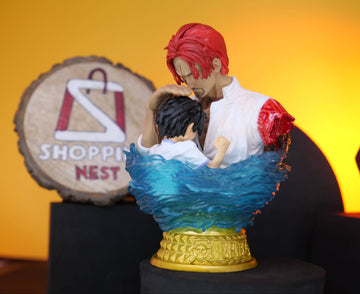 Figurine of a LUFFY AND SHANKS with red hair CLOSEUP on a stand with a 'Shopping Nest' sign in the background.
