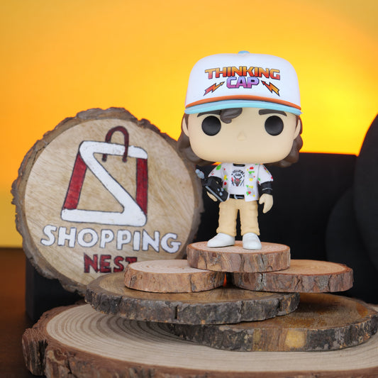Funko Pop! Stranger Things Dustin vinyl figure on a wooden stand with 'Shopping Nest' branding.