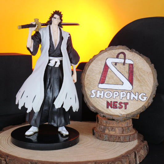 BLEACH ANIME KENPACHI character figurine with a sword next to a 'Shopping Nest' sign on a wooden surface.