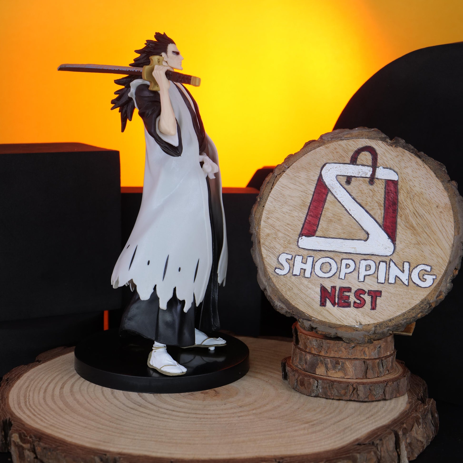 BLEACH KENPACHI Figurine of a character with a sword on a wooden stand with 'Shopping Nest' logo.