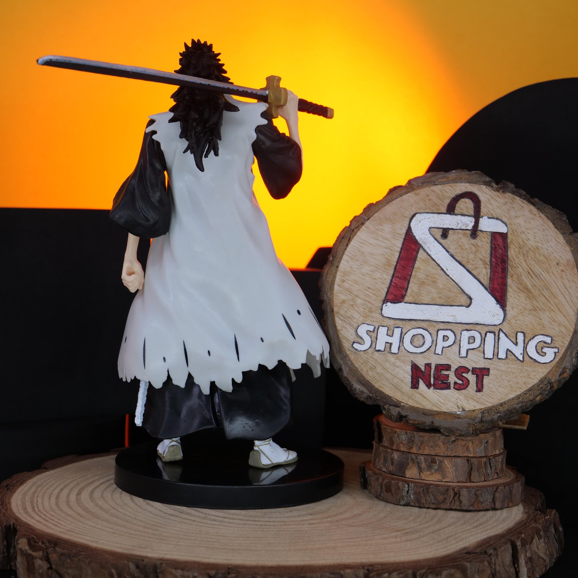 BLEACH KENPACHI Figurine of a character holding a sword on a wooden stand with 'Shopping Nest' logo in the background.