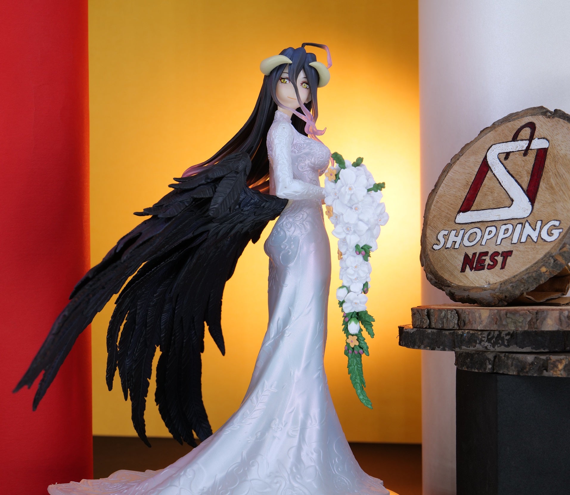Figurine of a character with long black hair and a white dress, holding flowers, against a colorful background with 'Shopping Nest' sign.