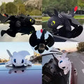 toothless Collage of dragon-shaped car visors on a car roof with different designs.